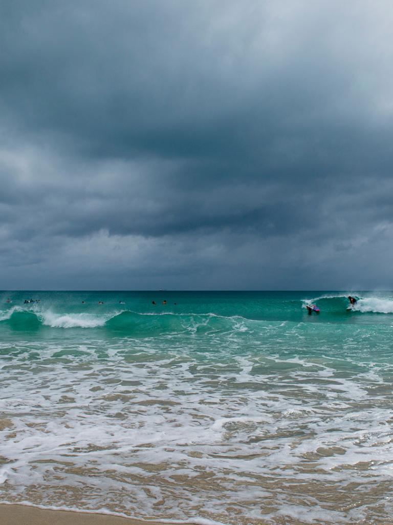 Storm clouds over a tropical beach. Credit: lazyllama 